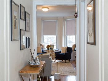 a living room with a couch and chairs and a table